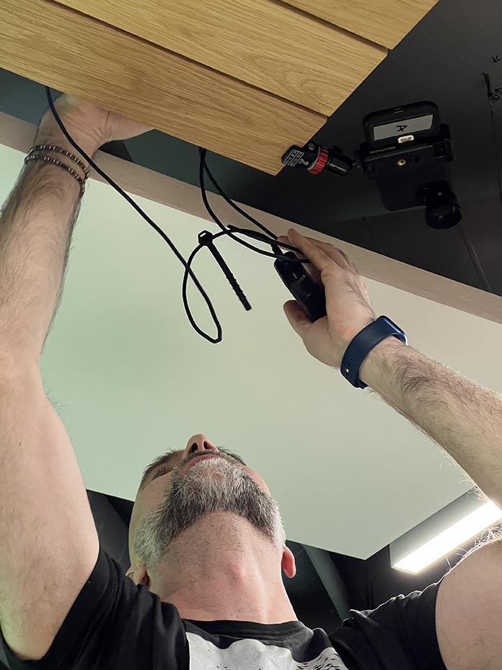 Człowiek montuje pod sufitem kamerę